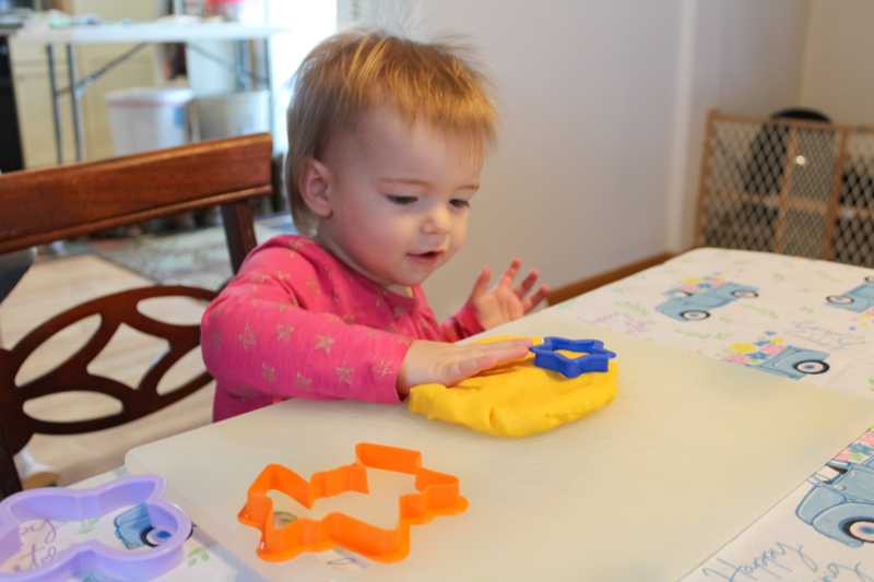 girl patting the gluten free playdoh